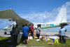 Passengers collect their baggage at an outer island airfield